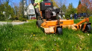 Closeup of a lawn mower mowing the lawn